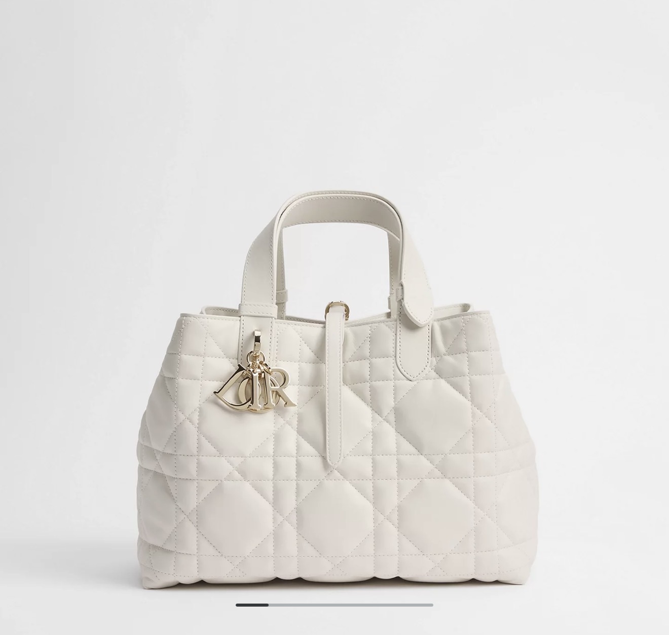 White quilted handbag with gold charm hardware